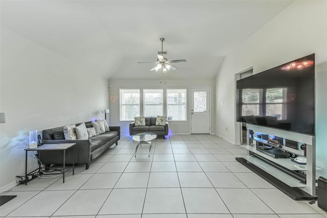 The living space is bright, open and airy, complemented by sleek tile flooring. | Image 14