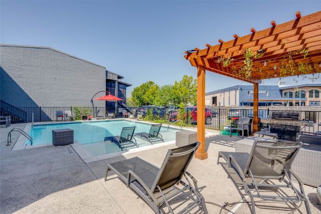 Community pool with a pergola and a patio area | Image 26