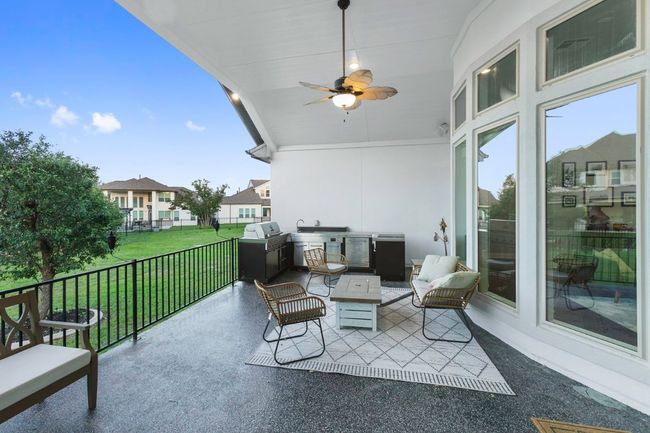 View of patio with ceiling fan and a residential view | Image 33