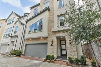 Welcome home to this luxurious 3 story home in a gated Heights subdivision with an elevator and 2 car garage plus additional parking space. | Image 1