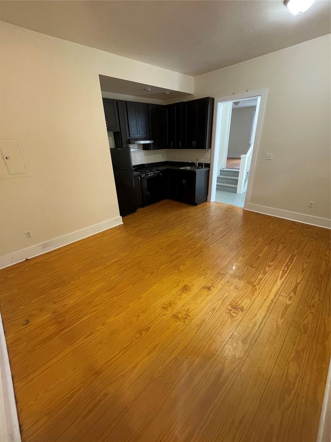 Unfurnished living room with light wood-type flooring and baseboards | Image 6
