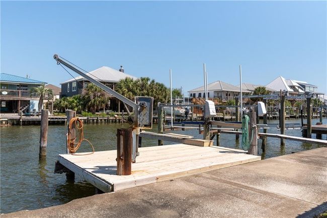 View of dock featuring jet ski lift and boat lift | Image 18