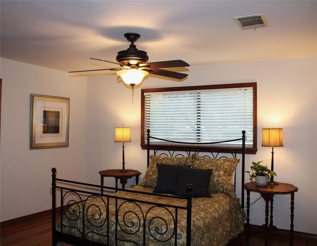Bedroom with baseboards and wood finished floors | Image 13