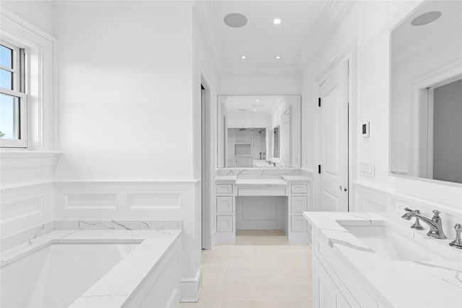 Half bathroom with toilet, wainscoting, vanity, and ornamental molding | Image 38