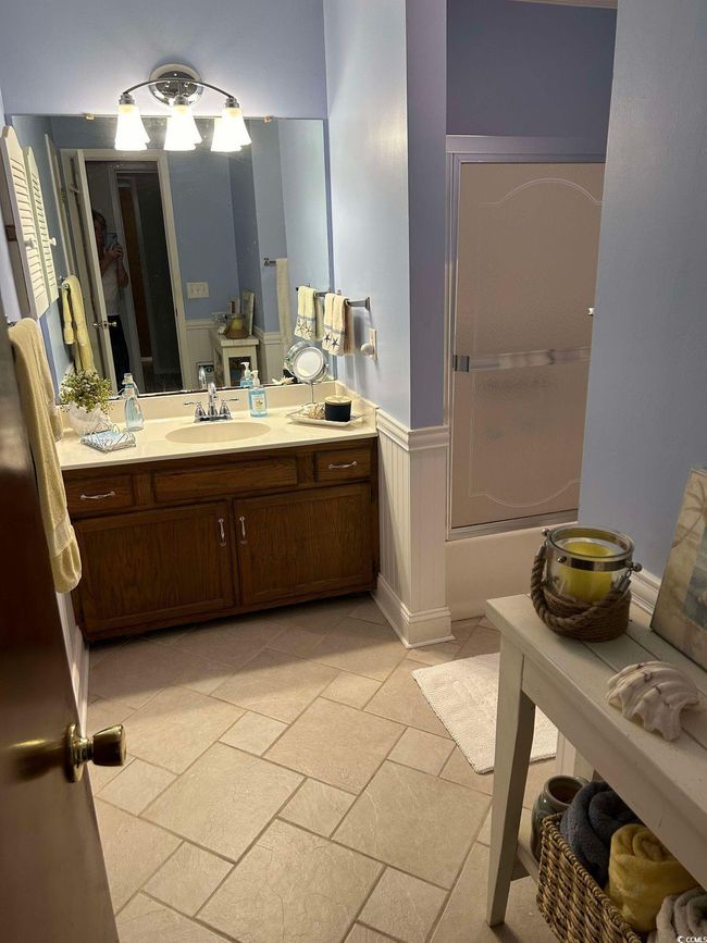 Bathroom with vanity, wainscoting, and shower / washtub combination | Image 18