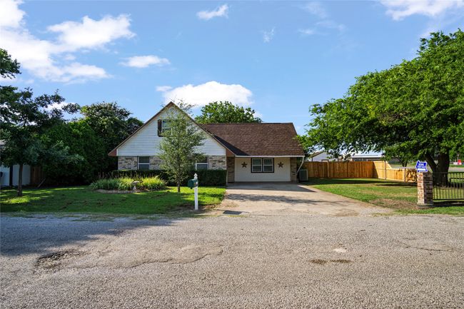 View of front facade featuring driveway and stone siding | Image 26