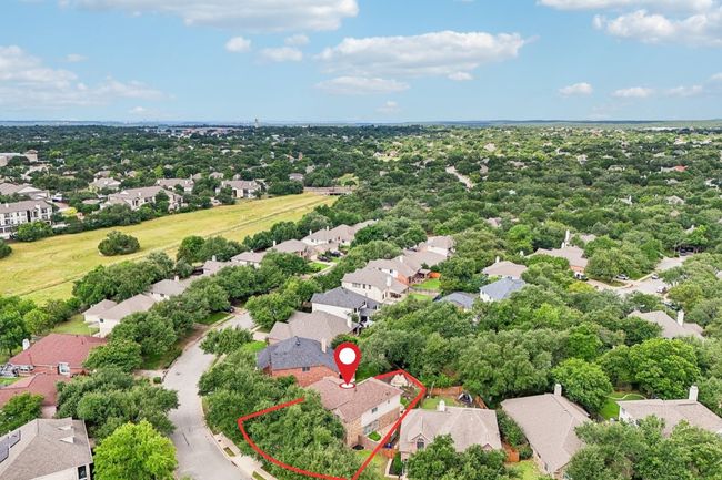 Situated on a spacious lot in a serene, tree-lined neighborhood. | Image 33