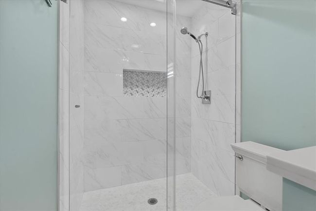 Bathroom with a shower with shower door and toilet | Image 31