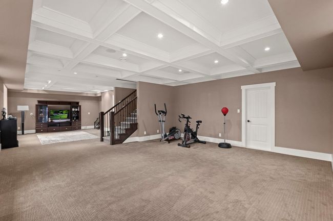 Workout room featuring baseboards, coffered ceiling, recessed lighting, and carpet | Image 32