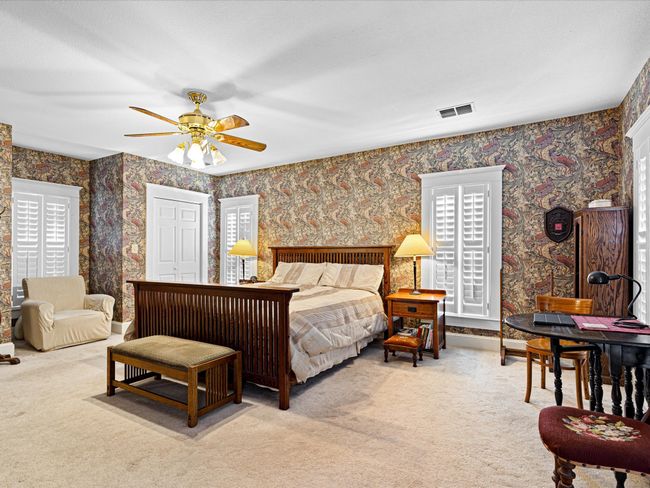 Stylish papered walls are consistent with the style and add a great amount of character to this lovely home. | Image 25