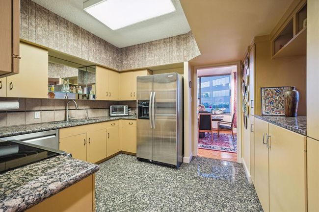 With two access points, the kitchen opens seamlessly into the living room, enhancing the flow of the space. | Image 16
