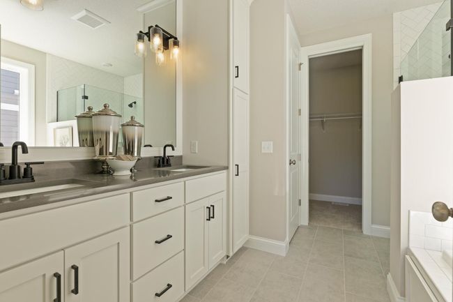 Owner's bath includes custom cabinets! including linen cabinet. Plus separate water closest! Photos may not depict actual home plan configuration. Features/materials/finishes shown contain options that are not included in price. | Image 12
