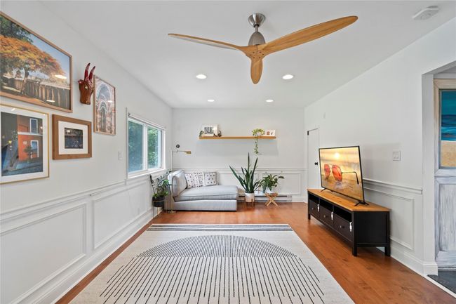 Living area with recessed lighting, light wood-type flooring, a lit fireplace, and a ceiling fan | Image 11