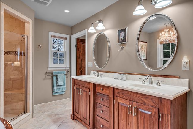 bathroom with double vanity, a sink, and a stall shower | Image 20