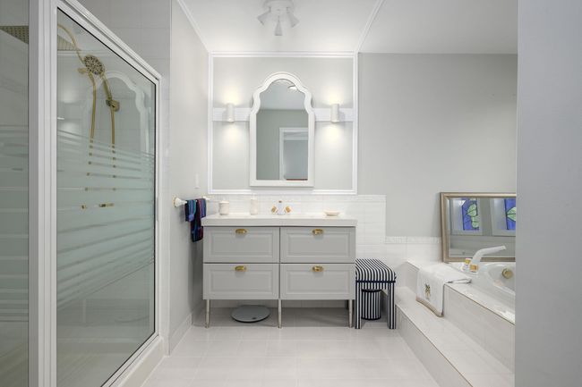 Bathroom with vanity, a stall shower, a bath, and tile patterned flooring | Image 17