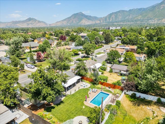 Aerial perspective of suburban area featuring a mountain backdrop and a pool area | Image 53