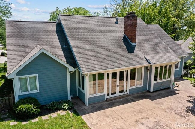 Back of property featuring a patio area, a chimney, a shingled roof, and french doors | Image 67