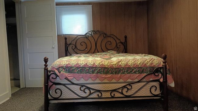 Carpeted bedroom featuring wood walls | Image 43