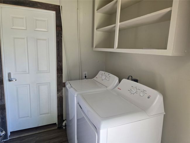 Laundry room with washing machine and clothes dryer and dark wood finished floors | Image 5