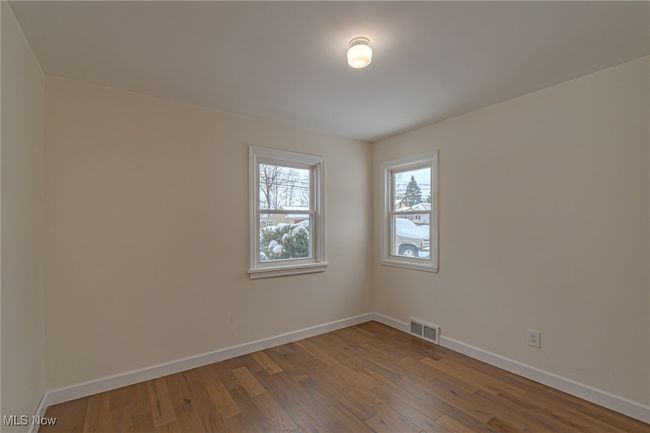 Spare room featuring wood-type flooring | Image 10