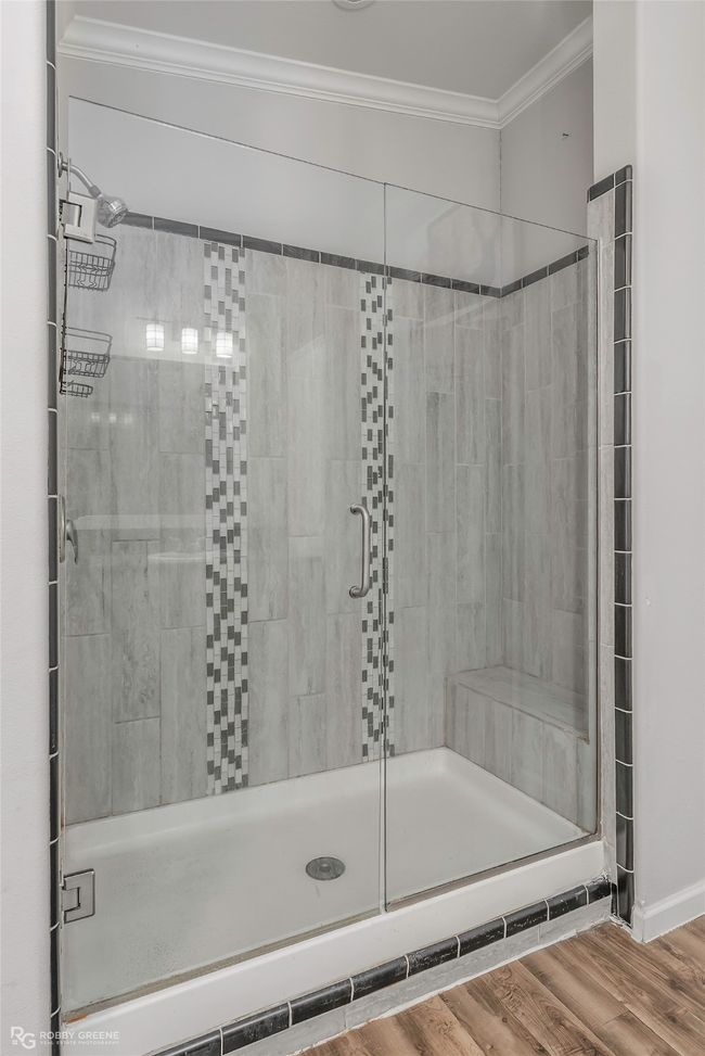 Full bathroom with a stall shower, wood finished floors, and crown molding | Image 29