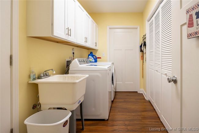 Large laundry area with custom cabinetry and utility sink | Image 44