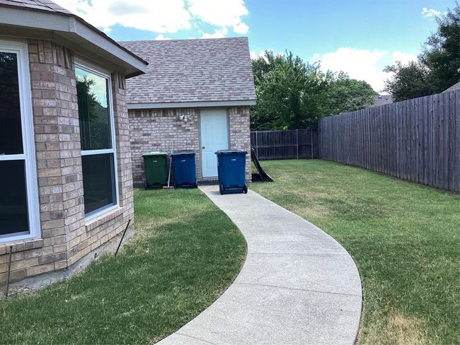 Fenced backyard featuring a storage shed | Image 31