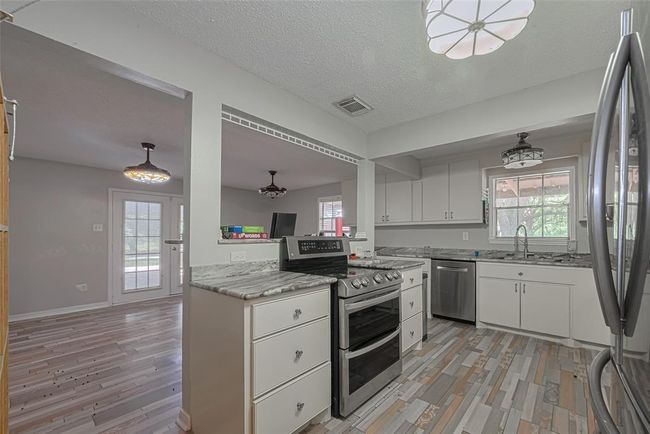 Bright kitchen space combined with a large dining room. | Image 13