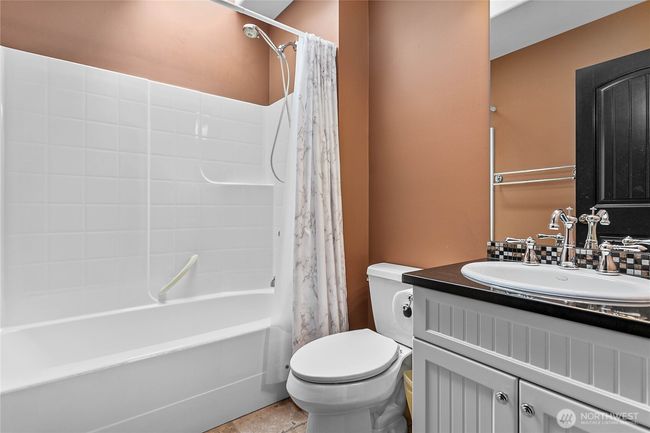 Upper full guest bathroom with skylight. | Image 22