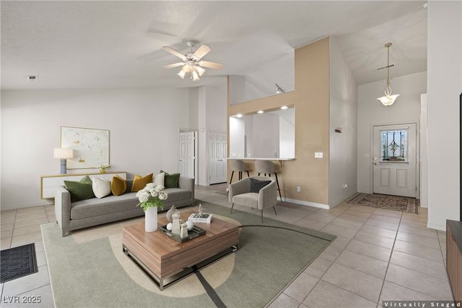 Tiled living area featuring high vaulted ceiling and a ceiling fan | Image 11