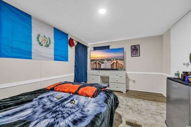 Bedroom featuring wood finished floors | Image 18