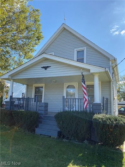 View of front of house featuring a front lawn and covered porch | Image 1