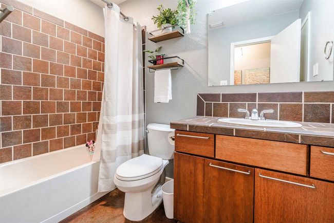 Full bath featuring vanity, decorative backsplash, toilet, and shower / tub combo | Image 13