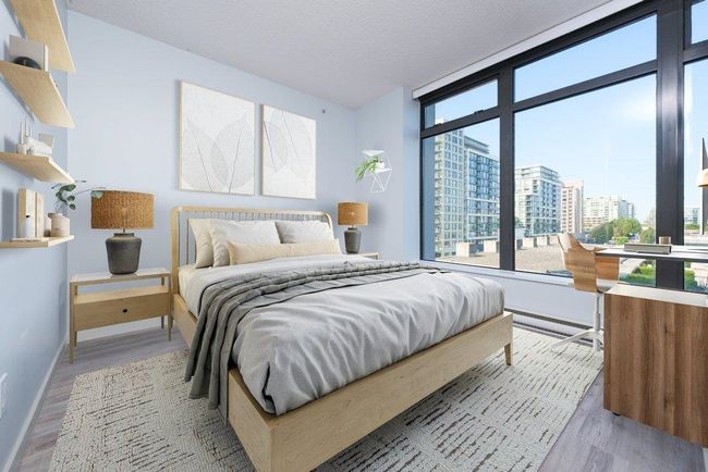 Bedroom featuring a city view, multiple windows, and wood finished floors | Image 11