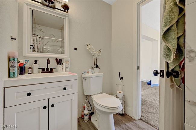 Full bathroom featuring vanity, wood finished floors, and a shower with curtain | Image 30