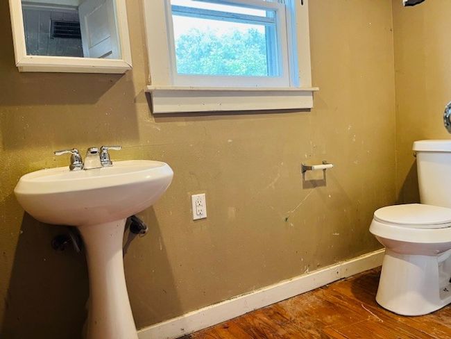 Bathroom with toilet, wood finished floors, and baseboards | Image 30