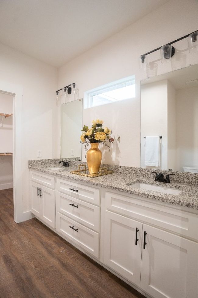 Full bathroom with double vanity, wood finished floors, and a spacious closet | Image 21