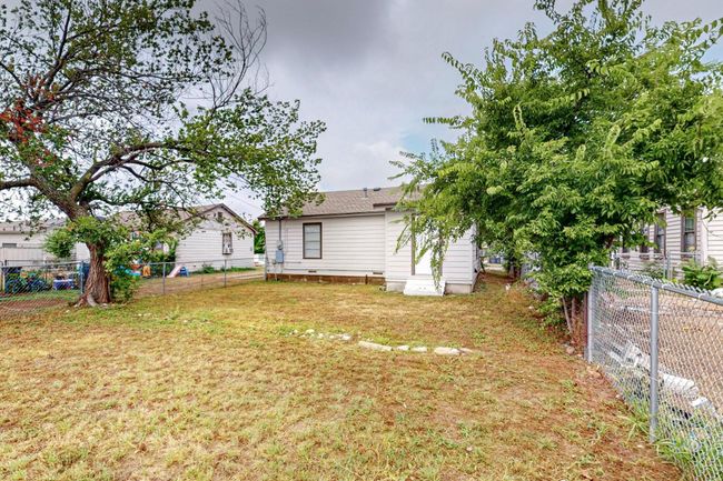 View of fenced backyard | Image 15