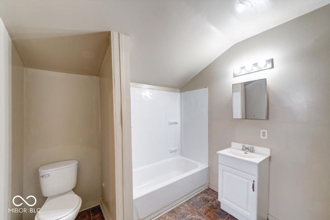 full bathroom featuring toilet, shower / washtub combination, vanity, and vaulted ceiling | Image 15