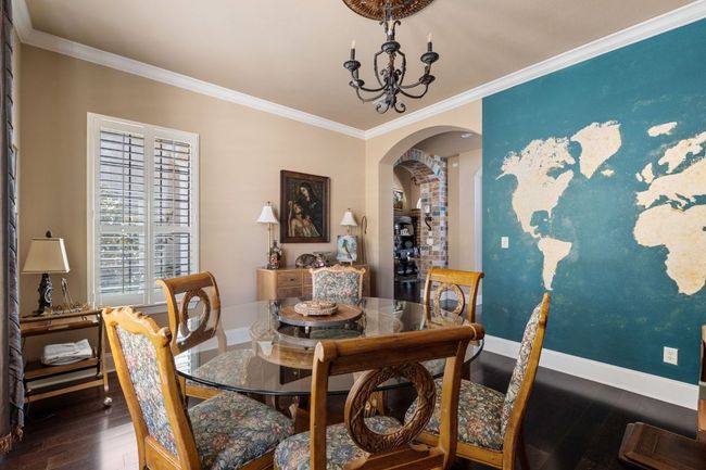 Dining area with hardwood flooring, arched walkways, and ornamental molding | Image 20