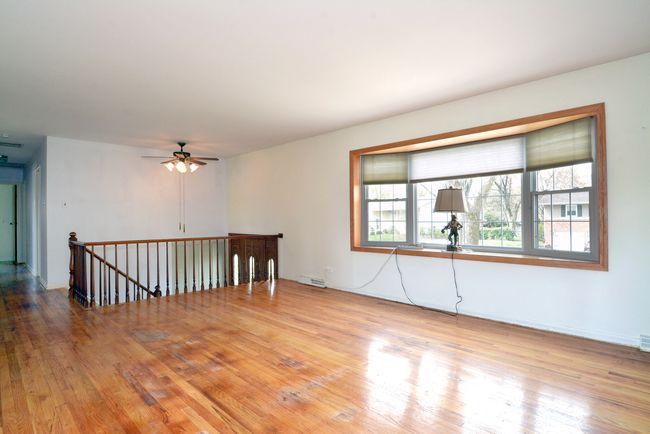 Living room with hardwood oak floors, bay window a | Image 5