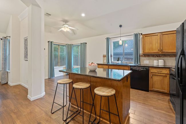 The kitchen is a gathering hub where everyone will want to gather around the inviting bar seating along the center island. | Image 13