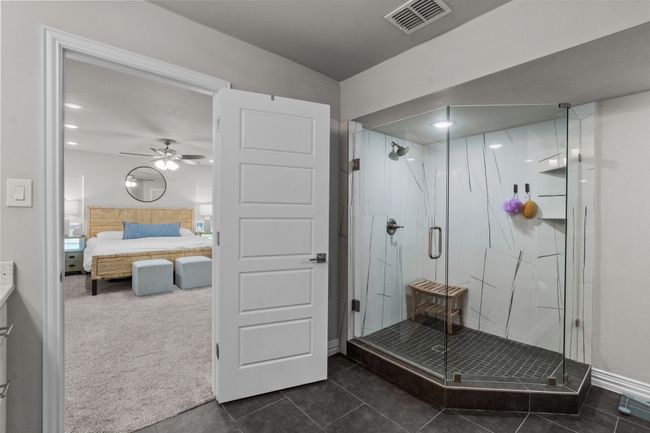 Primary Bathroom featuring double vanities, shower and primary closet | Image 21