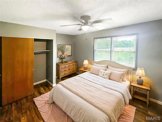 Bedroom with a closet, wood finished floors, and a ceiling fan | Image 12