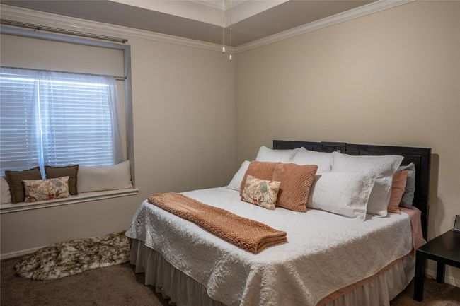 Carpeted bedroom featuring crown molding and a window nook | Image 11