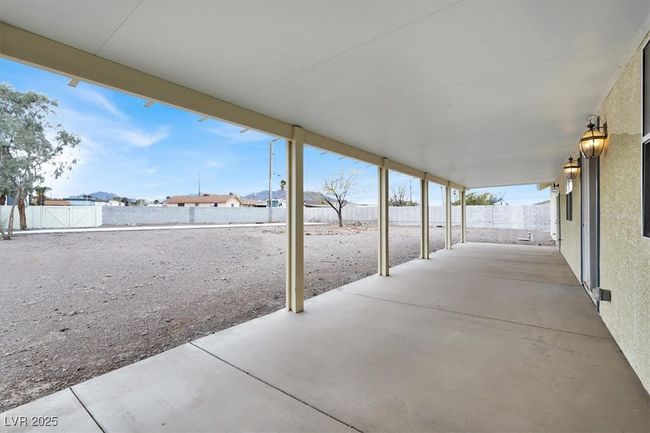 View of patio with a fenced backyard | Image 32