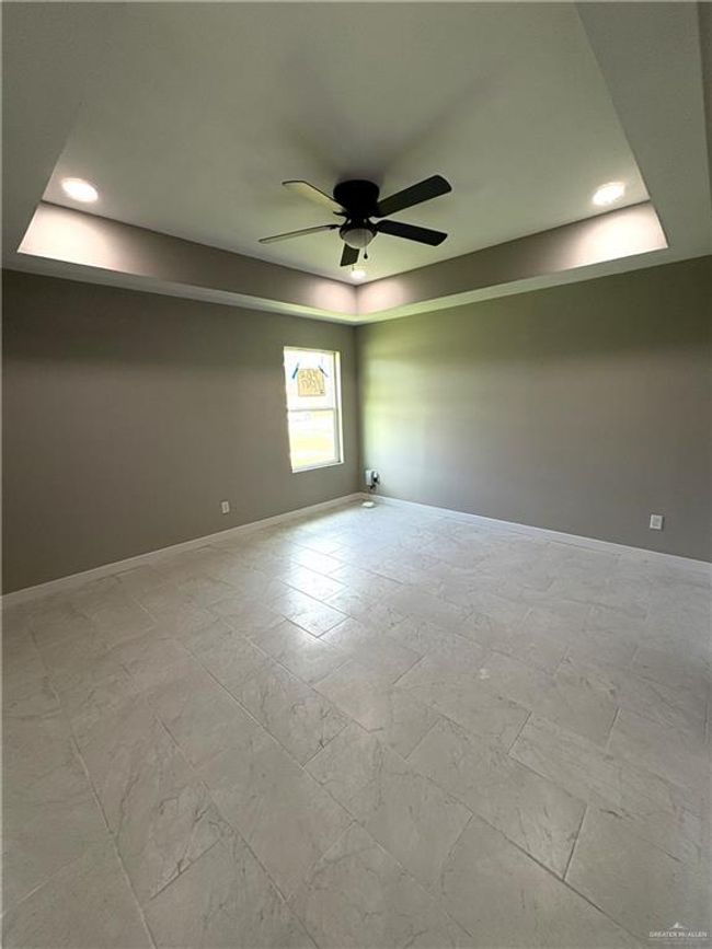 Unfurnished room with a raised ceiling, a ceiling fan, and recessed lighting | Image 6