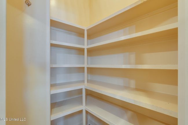 spacious pantry with wood shelves | Image 30