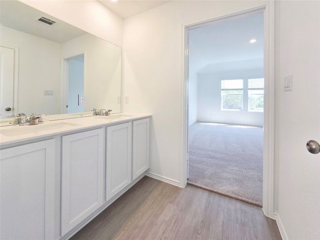 Full bathroom featuring double vanity, wood finished floors, and baseboards | Image 12