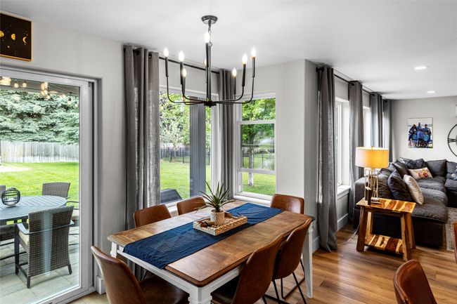 Dining area featuring healthy amount of natural light, wood finished floors, a chandelier, and recessed lighting | Image 26